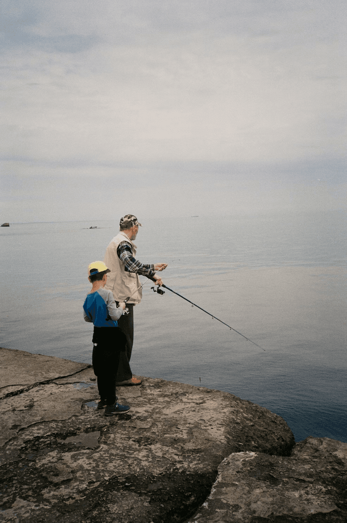 A family fishing together by a lake