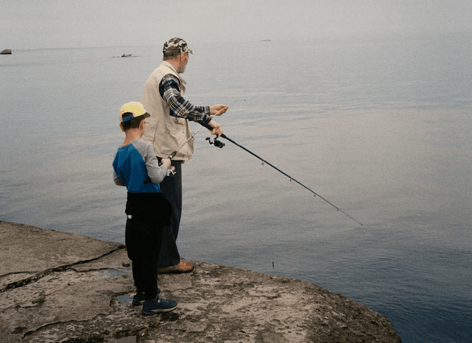 A family fishing together by a lake